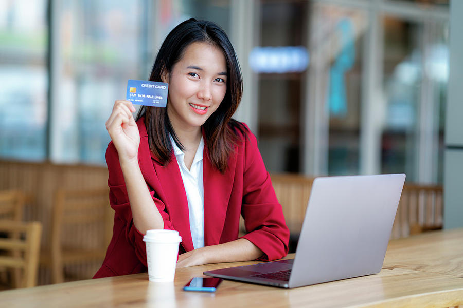 Menina asiática fazendo compras on-line com cartão de crédito